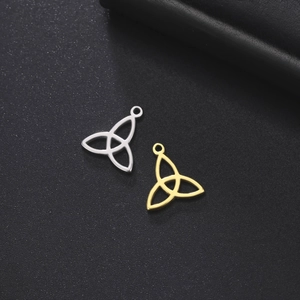 Detailed macro view of gold and silver Triquetra pendants for DIY jewelry making