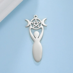 Macro view of silver stainless steel Mother Goddess and Triple Moon charm pendant