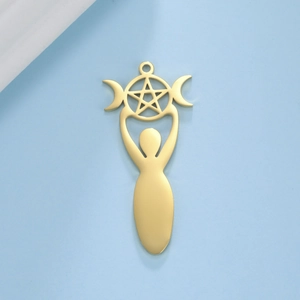 Macro shot of gold stainless steel Wicca goddess pendant with pentagram on blue surface