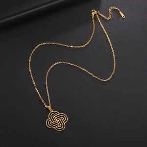 Detail showing the intricate golden Celtic knot pendant on a black leather surface