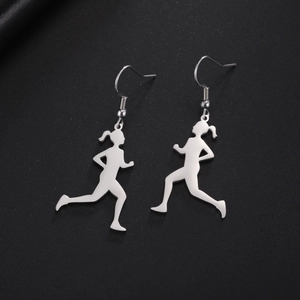 Polished stainless steel dangle earrings featuring running girl silhouettes on a dark background