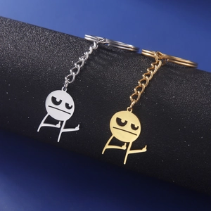 Primo piano di portachiavi stickman in acciaio inossidabile oro e argento su basi nere