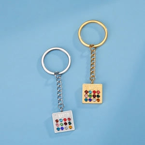 Detail of gold and silver keychains with Hoshen stone pendant and Hebrew engraving