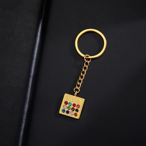 Detailed view of Hoshen pendant keychain with twelve colorful stones on black leather