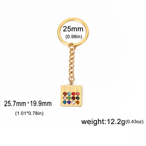Detailed view of golden keychain with Hebrew pendant and twelve colorful gemstones