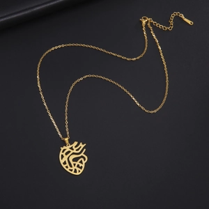 Detail of anatomical heart pendant in gold finish with lobster clasp and extender chain