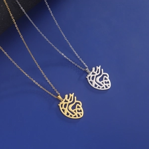 Detail of anatomical heart pendants in gold and silver finish with hollow-out design
