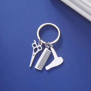 Detail of silver stainless steel barber tool charms with scissors comb and hairdryer
