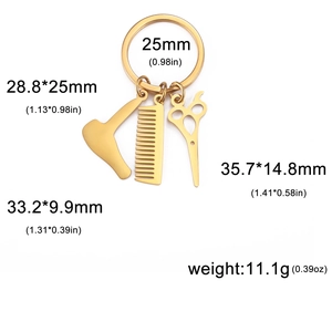 Detail view of gold barber tools keychain showing dimensions for comb and dryer charms