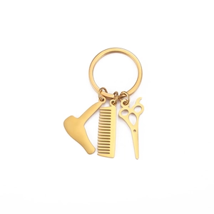 Golden stainless steel barber keychain featuring mini hair dryer, comb, and scissors charms