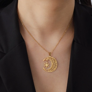 Elegant gold titanium moon and snowflake pendant necklace for women on a model