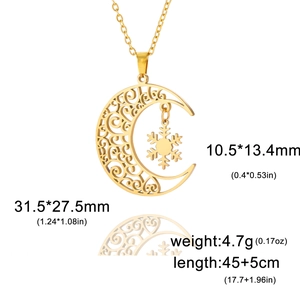 Detailed view of a gold crescent moon and snowflake pendant with ornate scroll patterns