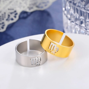 Detailed view of gold and silver Virgo zodiac rings on a white display with elegant decor