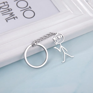 Detail shot of a silver stainless steel keychain featuring a cool stickman with sunglasses
