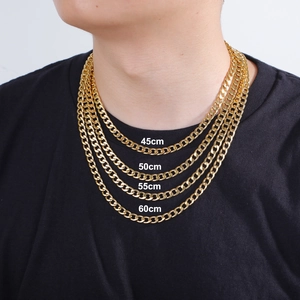 Classic gold stainless steel Cuban link chains in four lengths 45cm to 60cm on a black shirt