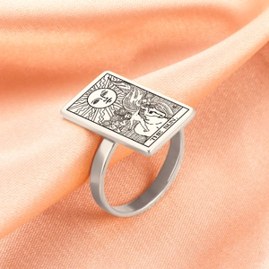 Macro shot of silver stainless steel ring featuring The Sun tarot card engraving