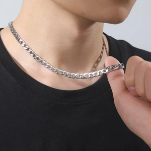 Men's silver cuban link chain necklace in stainless steel on a male model with black t-shirt