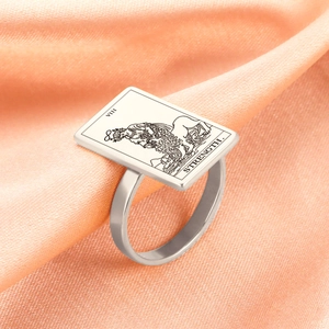 Macro shot of the Strength Tarot VIII engraving on a rectangular silver stainless steel ring