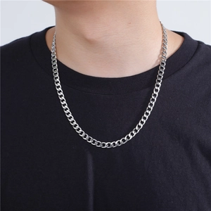 Classic silver stainless steel Cuban link necklace shown on model with black t-shirt