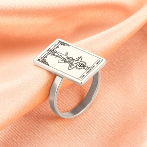 Macro view of silver stainless steel ring featuring The Hanged Man tarot card design