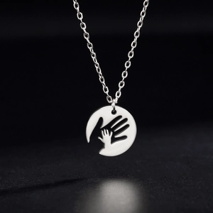 Polished stainless steel round pendant necklace featuring mother and child handshake design