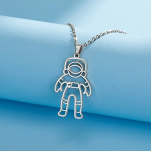 Macro view of minimalist silver astronaut pendant with polished stainless steel chain