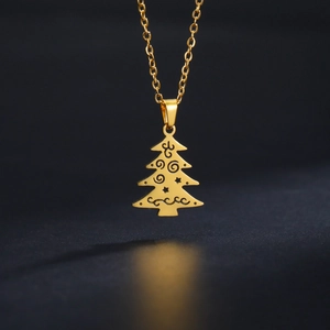 Detalle del colgante de árbol de Navidad dorado con grabados de estrellas y espirales
