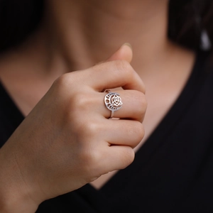 Detail of Celtic knot and crescent moon cutouts on a vintage polished silver ring