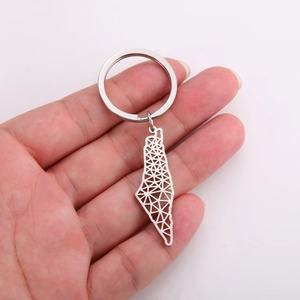 Minimalist stainless steel keychain with hollow geometric map pendant held in hand