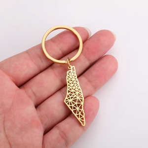 Detailed view of golden stainless steel keychain with hollow geometric map design pendant