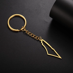 Detailed close-up of a gold-plated stainless steel hollow map pendant keychain on black
