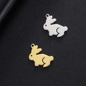 Polished gold and silver rabbit charms on dark leather for DIY jewelry making