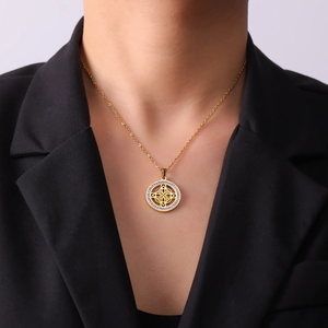Detail of gold Celtic knot pendant necklace featuring sparkling zircon crystals on model