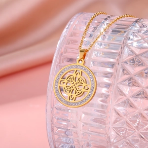 Detail of gold-plated Celtic Knot pendant necklace with sparkling zircon outer ring inlay