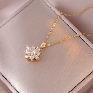 Exquisite gold rotating flower necklace with zircon crystals on a luxury display box
