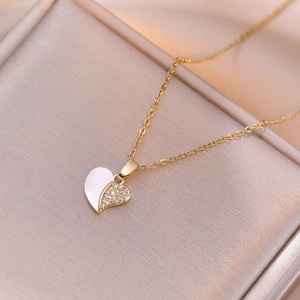 Elegant gold heart pendant necklace with shell inlay and shimmering cubic zirconia stones