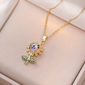 Golden sunflower necklace with multicolored zircon pendant on a silk jewelry box