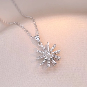 Elegant rotating sunflower necklace with silver starburst pendant and sparkling crystals