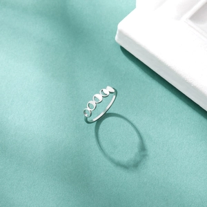 Detailed view of silver moon phase ring showing waxing and waning crescent moon designs
