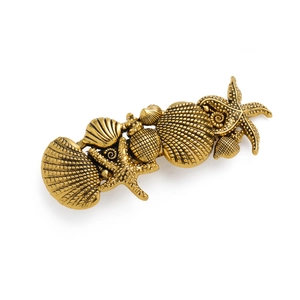 Vintage gold starfish and seashell hair clip with detailed marine life embossing