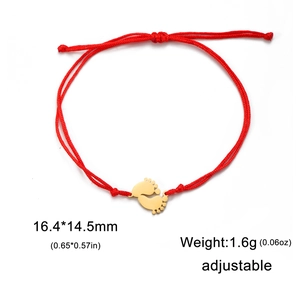 Detail view of red rope bracelet with golden footprint pendant and dimension markers