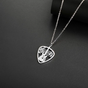 Detailed macro view of silver guitar pick pendant with music notes and O-chain