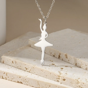 Detailed macro view of silver ballet dancer silhouette pendant on polished O-chain