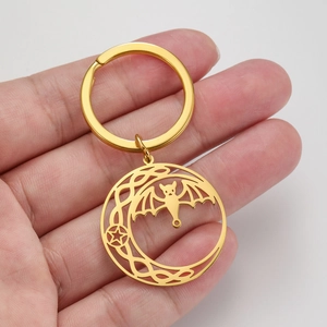 Golden stainless steel keychain with bat, crescent moon, and pentagram cutout charms