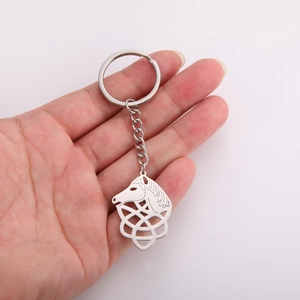 Polished silver stainless steel horse head keychain with Celtic knot charm held in hand