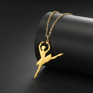 Detailed view of a gold ballet dancer silhouette pendant on a delicate chain necklace