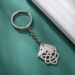 Macro view of silver stainless steel horse head keychain with intricate Celtic knot patterns