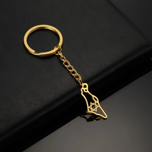 Detail view of a gold-plated stainless steel keychain with map cutout and star design