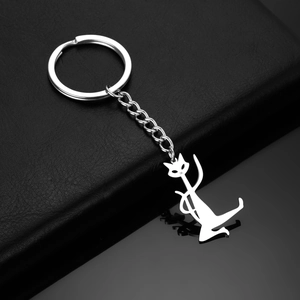 Detailed view of polished stainless steel cat pendant on sleek black leather background