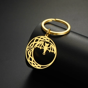 Detail of golden stainless steel keychain with hollow bat, crescent moon and star pendant